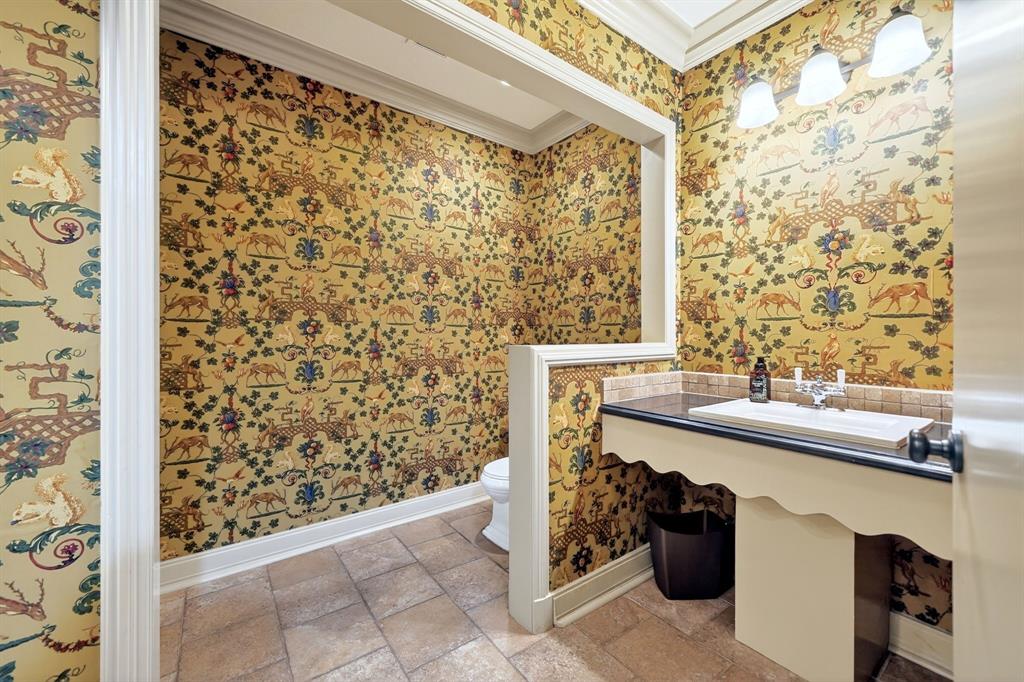 1901 Rose Pointe Athens, TX 75752 - Photo 23 of 37 Powder room featuring detailed patterned wallpaper, a bespoke vanity with an integrated sink, a dark countertop, and a tiled backsplash