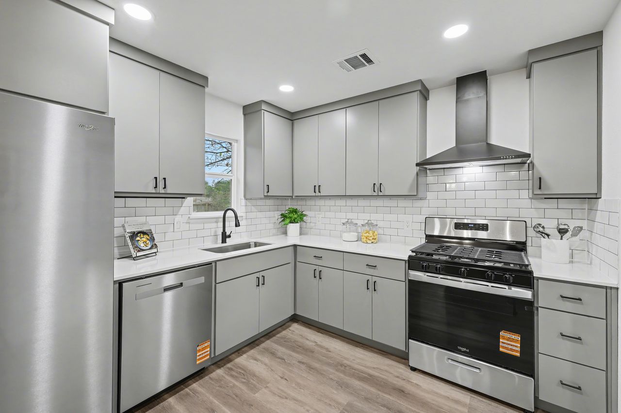 2103 Fordham Cove Austin, TX 78723 - Photo 10 of 36 a kitchen with a sink stainless steel appliances and cabinets