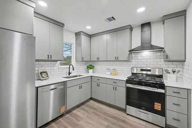 a kitchen with a stove and a sink