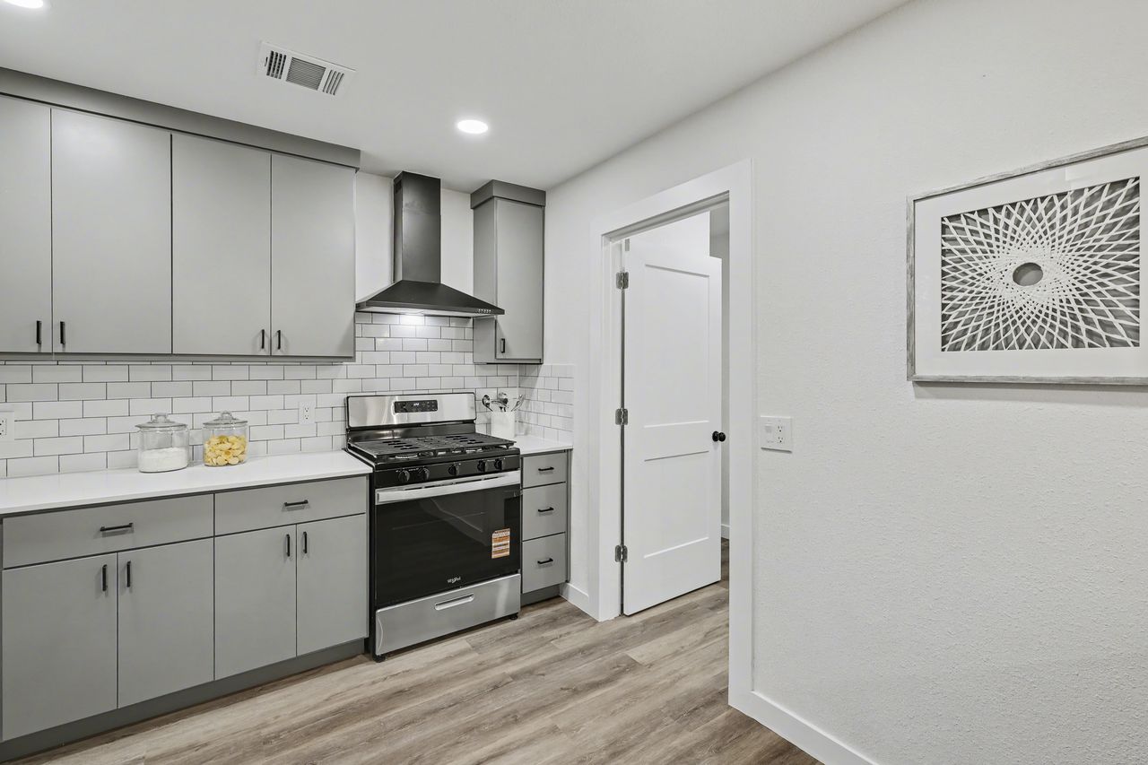 2103 Fordham Cove Austin, TX 78723 - Photo 11 of 36 a kitchen with a stove and a sink