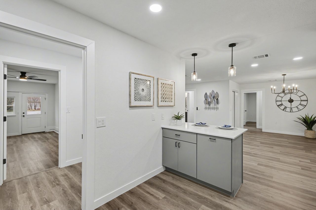 2103 Fordham Cove Austin, TX 78723 - Photo 12 of 36 a view of a room with wooden floor and cabinet