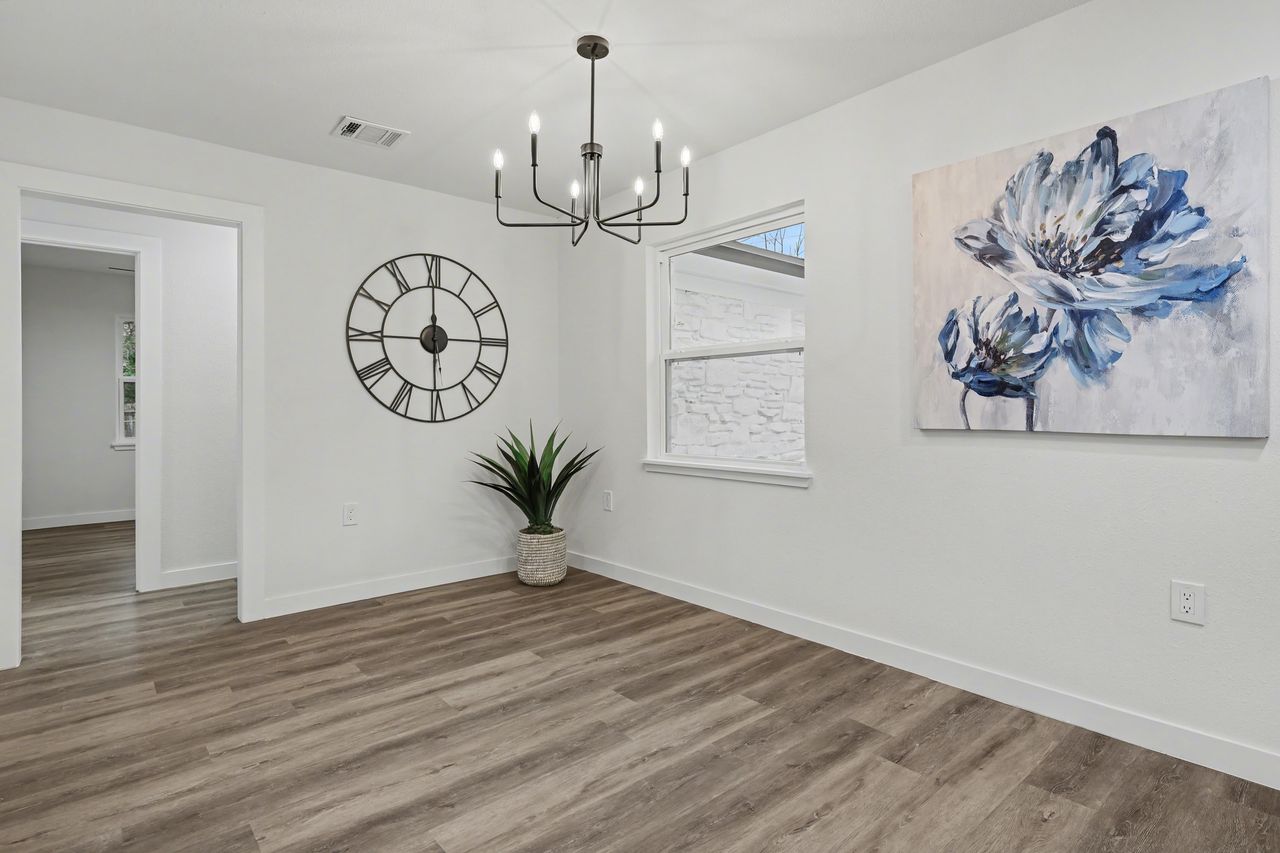 2103 Fordham Cove Austin, TX 78723 - Photo 13 of 36 a view of a hallway with paintings on the wall