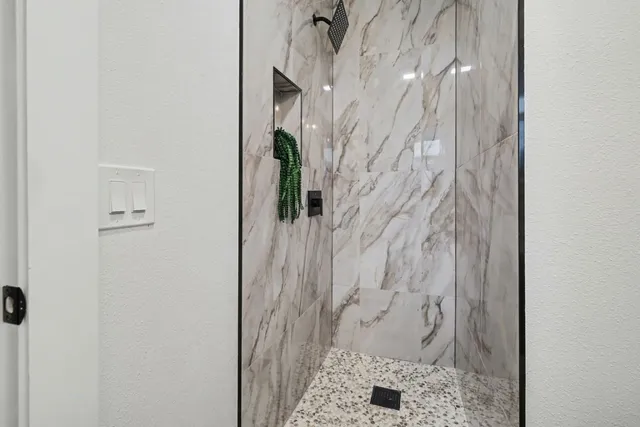 a bathroom with a toilet a sink a tub and a mirror