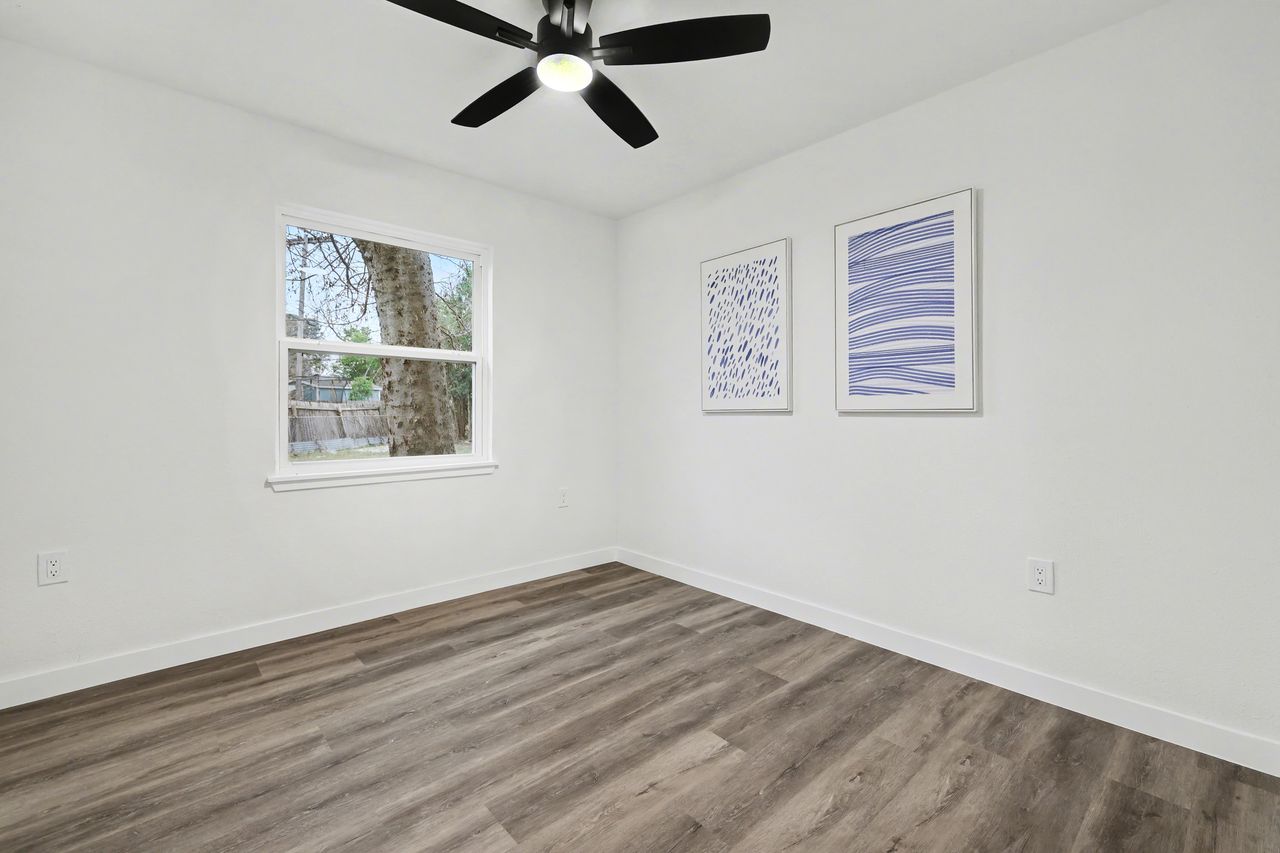 2103 Fordham Cove Austin, TX 78723 - Photo 21 of 36 a view of a room with wooden floor and windows