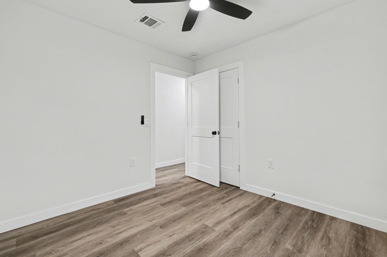 2103 Fordham Cove Austin, TX 78723 - Photo 22 of 36 wooden floor in an empty room