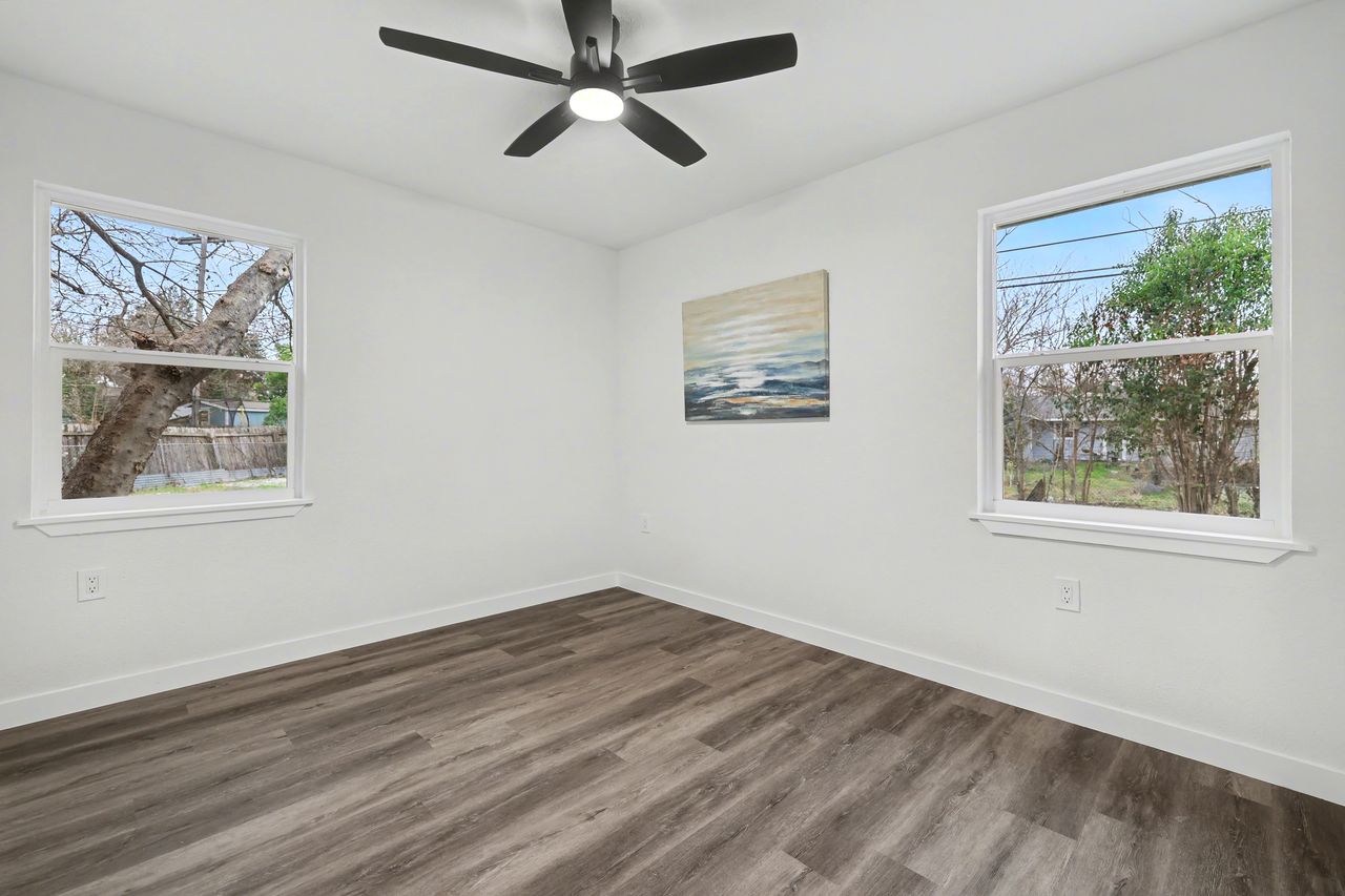 2103 Fordham Cove Austin, TX 78723 - Photo 23 of 36 a view of empty room with wooden floor and fan