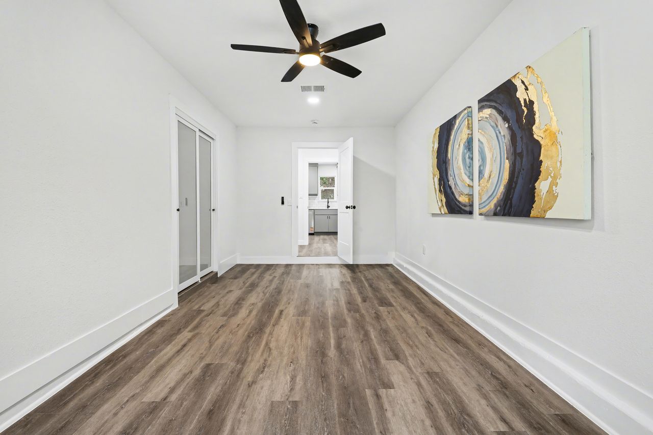 2103 Fordham Cove Austin, TX 78723 - Photo 28 of 36 wooden floor in an empty room with a window
