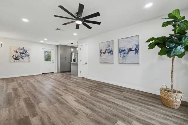 a view of an empty room with a painting on the wall