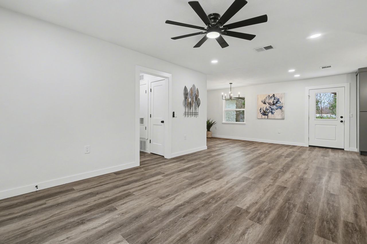 2103 Fordham Cove Austin, TX 78723 - Photo 4 of 36 an empty room with wooden floor and windows