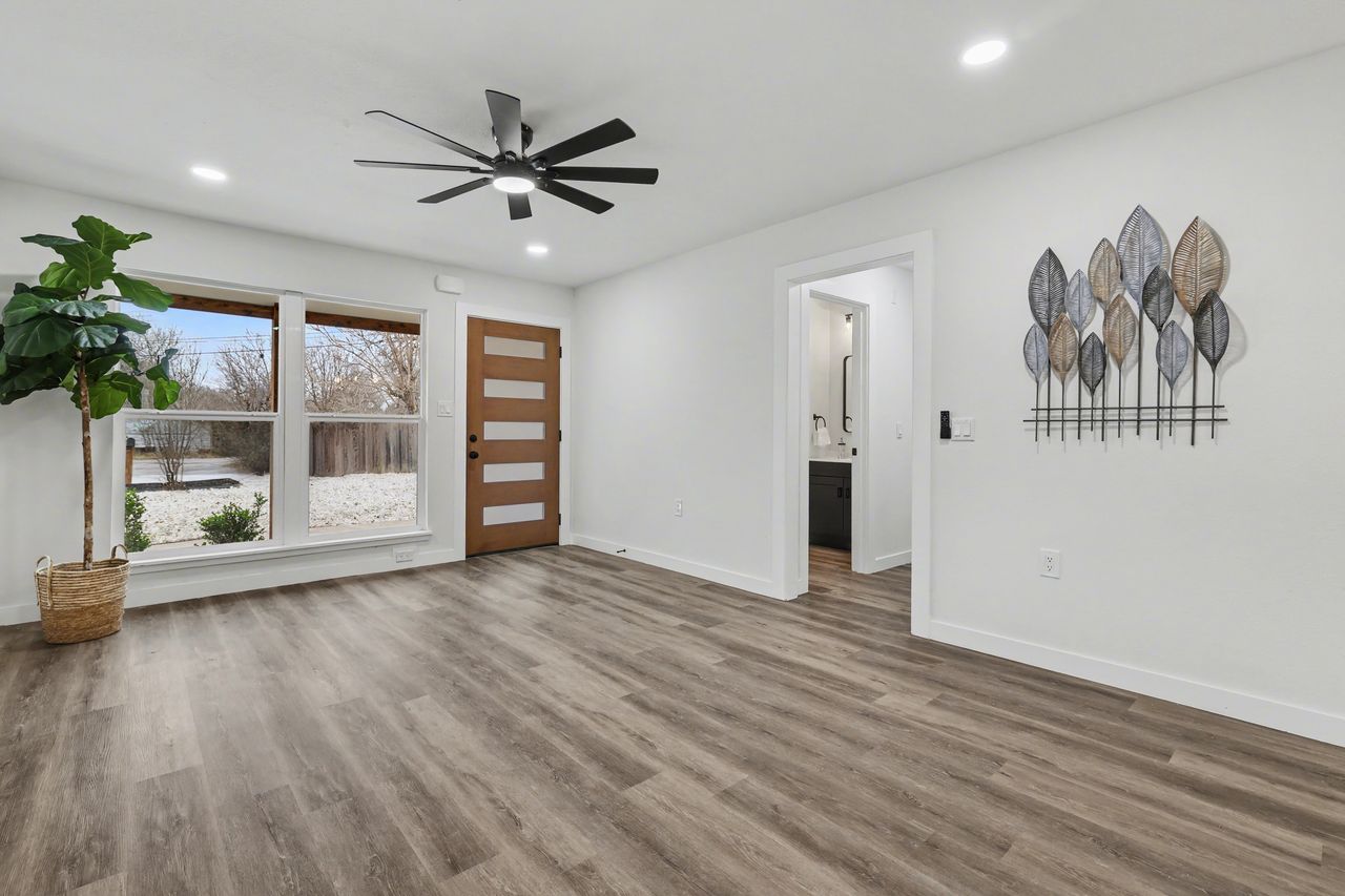 2103 Fordham Cove Austin, TX 78723 - Photo 5 of 36 a view of a livingroom with a ceiling fan window and wooden floor