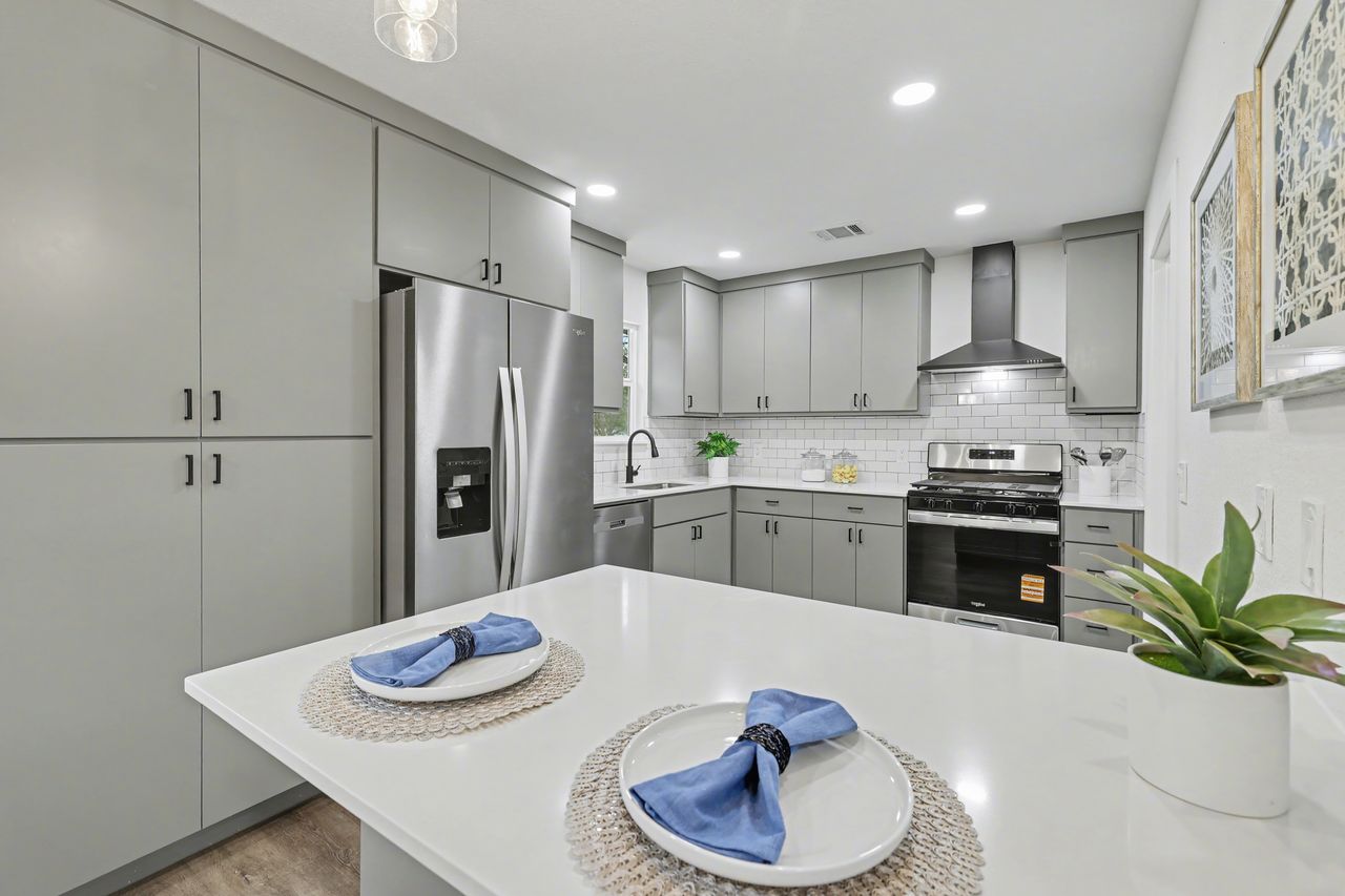 2103 Fordham Cove Austin, TX 78723 - Photo 8 of 36 a kitchen with a sink stove and refrigerator