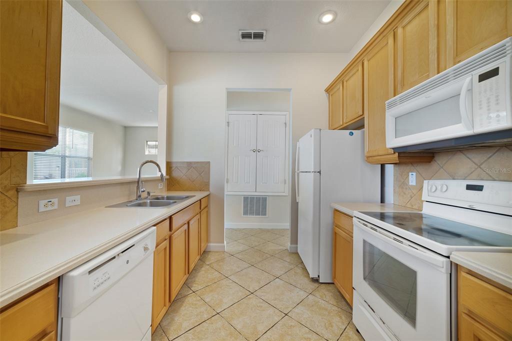 7740 Linkside Loop Reunion, FL 34747 - Photo 11 of 34 a kitchen that has a sink and a stove in it