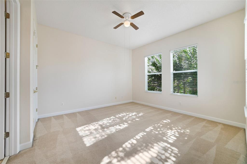 7740 Linkside Loop Reunion, FL 34747 - Photo 16 of 34 an empty room with windows and ceiling fan