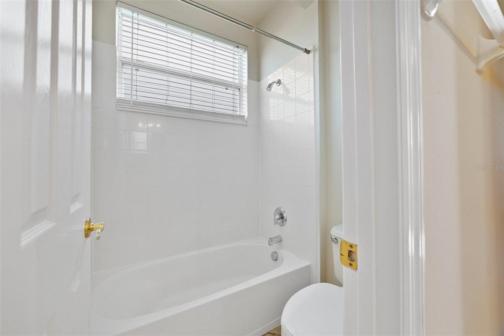7740 Linkside Loop Reunion, FL 34747 - Photo 18 of 34 a bathroom with a bathtub and a shower