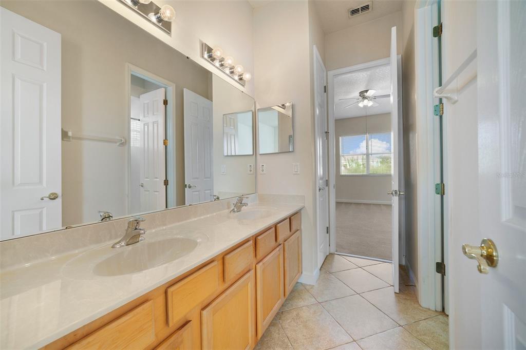 7740 Linkside Loop Reunion, FL 34747 - Photo 19 of 34 a bathroom with a sink and a mirror