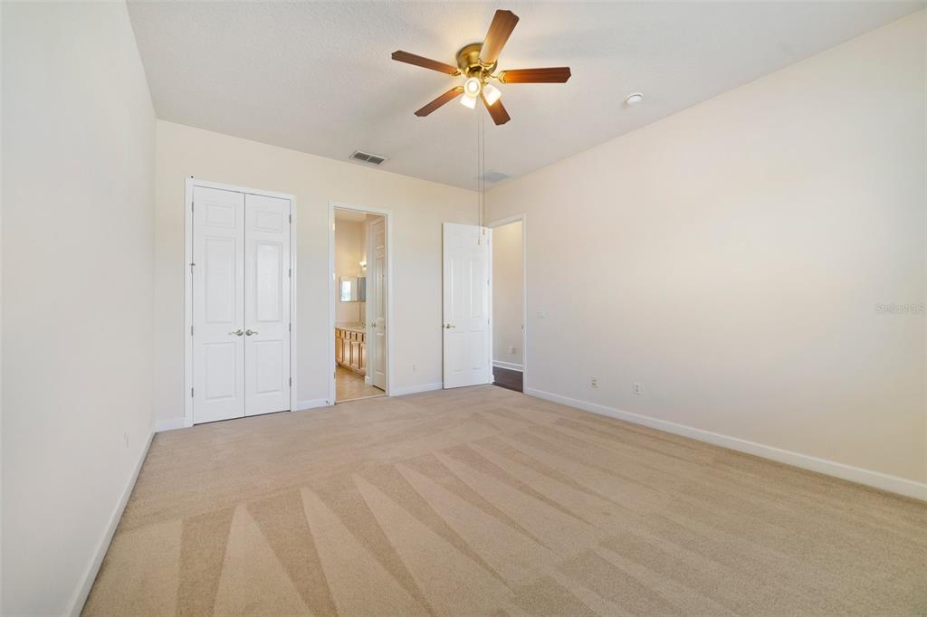 7740 Linkside Loop Reunion, FL 34747 - Photo 20 of 34 a view of a big room with closet and fan