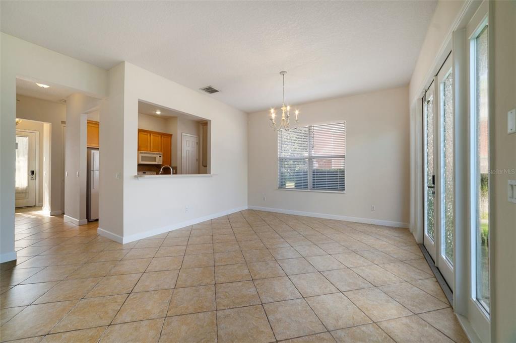 7740 Linkside Loop Reunion, FL 34747 - Photo 6 of 34 a view of an empty room with window and chandelier fan