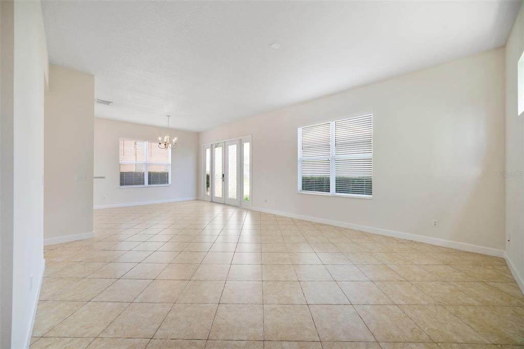 7740 Linkside Loop Reunion, FL 34747 - Photo 8 of 34 an empty room with windows and pillars in it