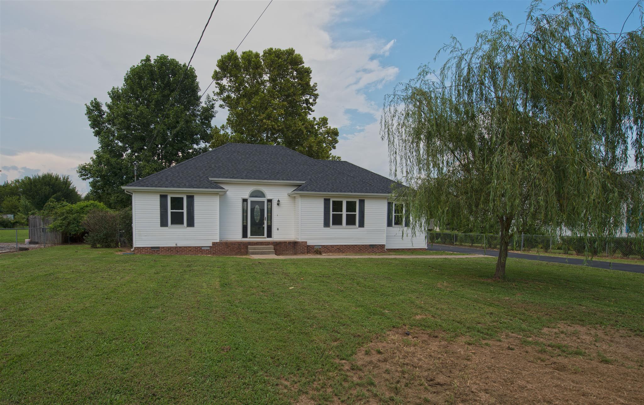 7500 Joe Rowlin Road Christiana, TN 37037 - Photo 2 of 22 a front view of a house with a garden