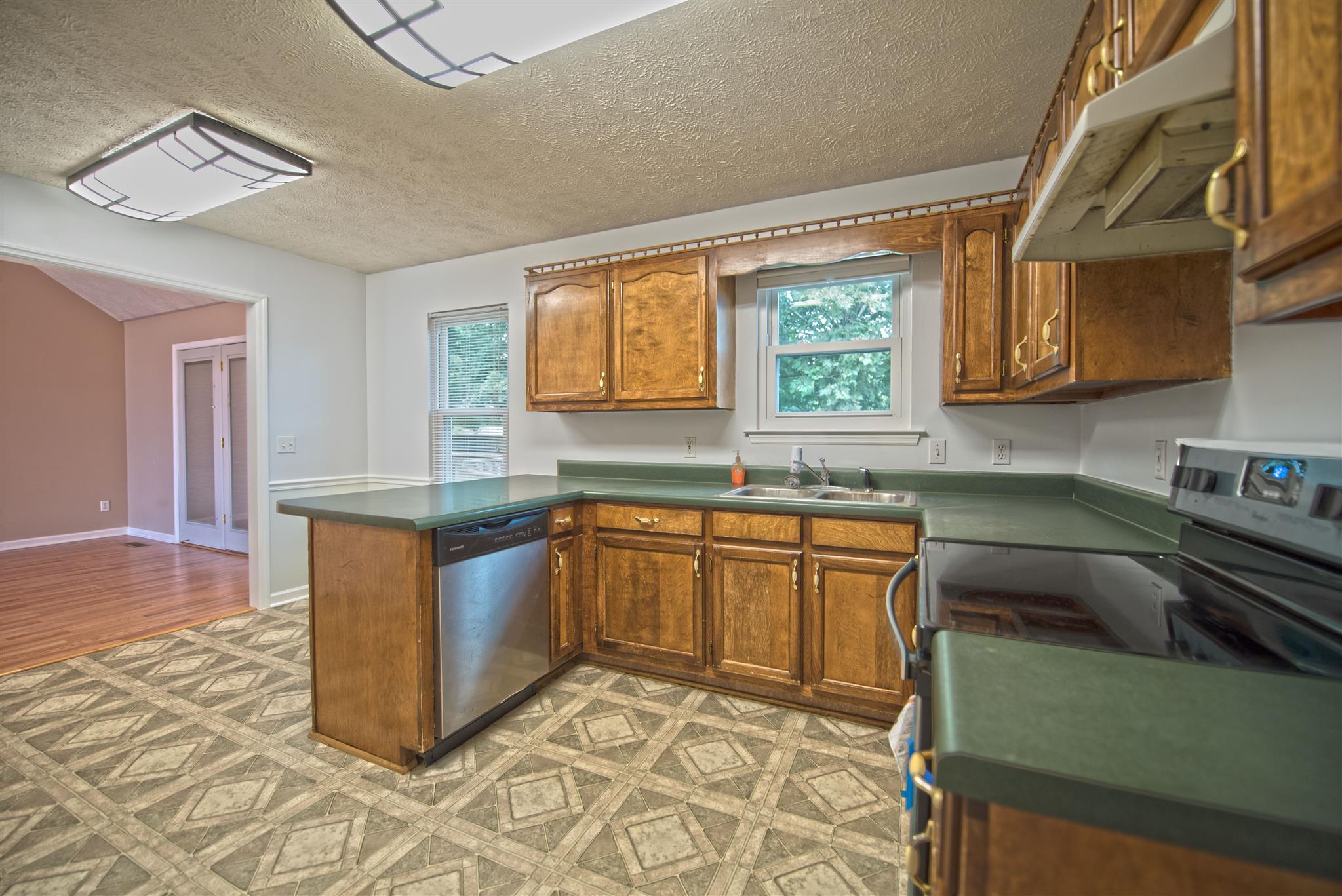 7500 Joe Rowlin Road Christiana, TN 37037 - Photo 11 of 22 a kitchen with stainless steel appliances granite countertop a sink and a stove