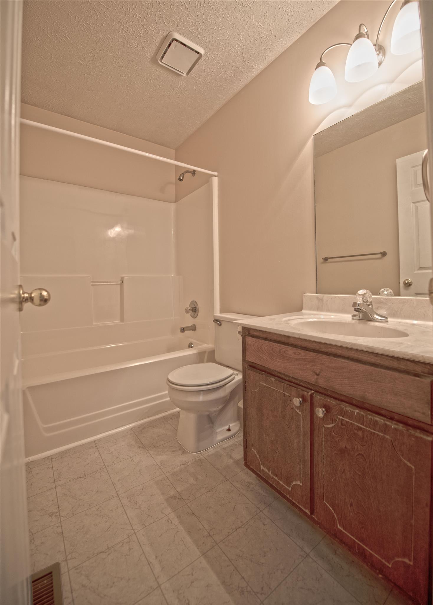 7500 Joe Rowlin Road Christiana, TN 37037 - Photo 17 of 22 a bathroom with a double vanity sink toilet and shower