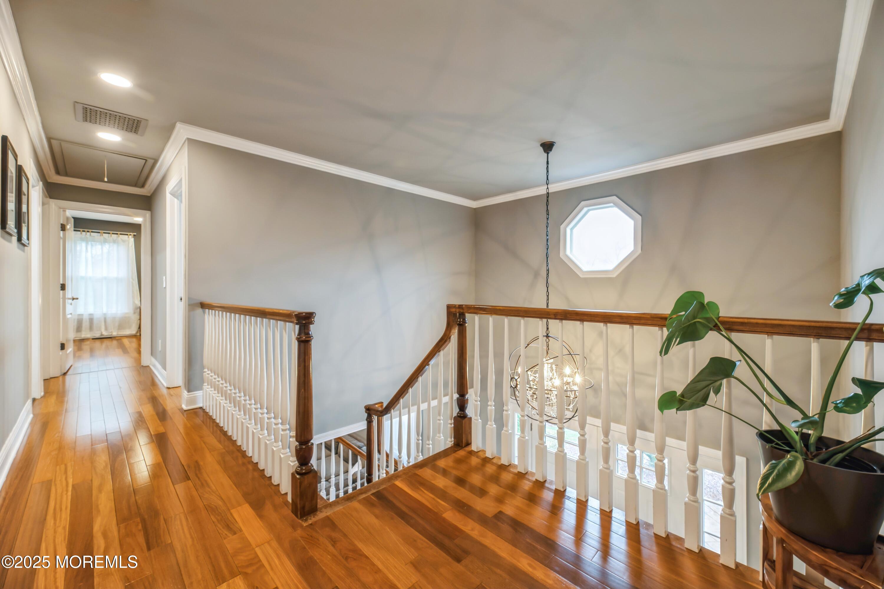 44 Manor Drive Marlboro, NJ 07746 - Photo 13 of 26 a view of staircase with railing and a chandelier