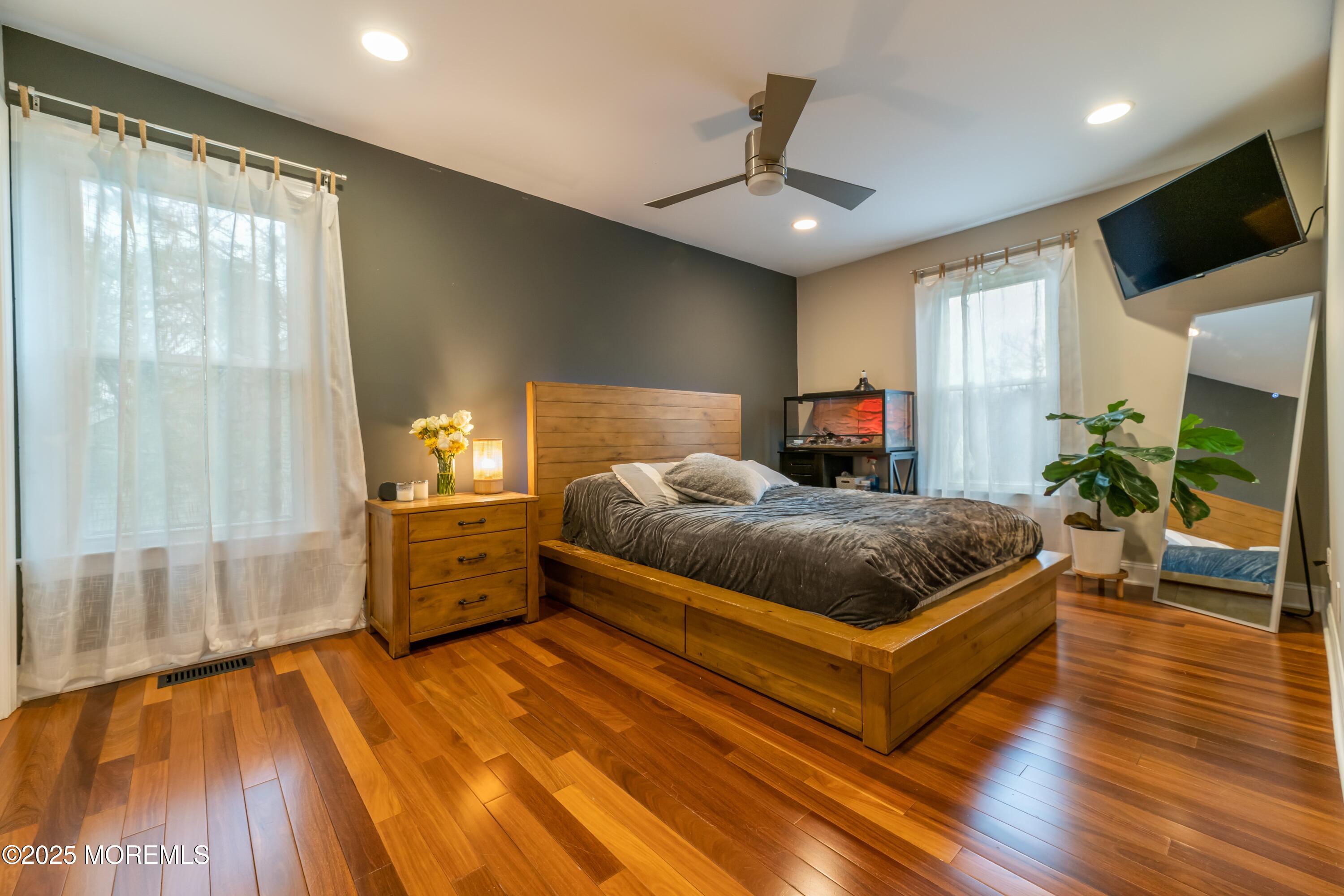 44 Manor Drive Marlboro, NJ 07746 - Photo 17 of 26 a spacious bedroom with a bed and a flat screen tv