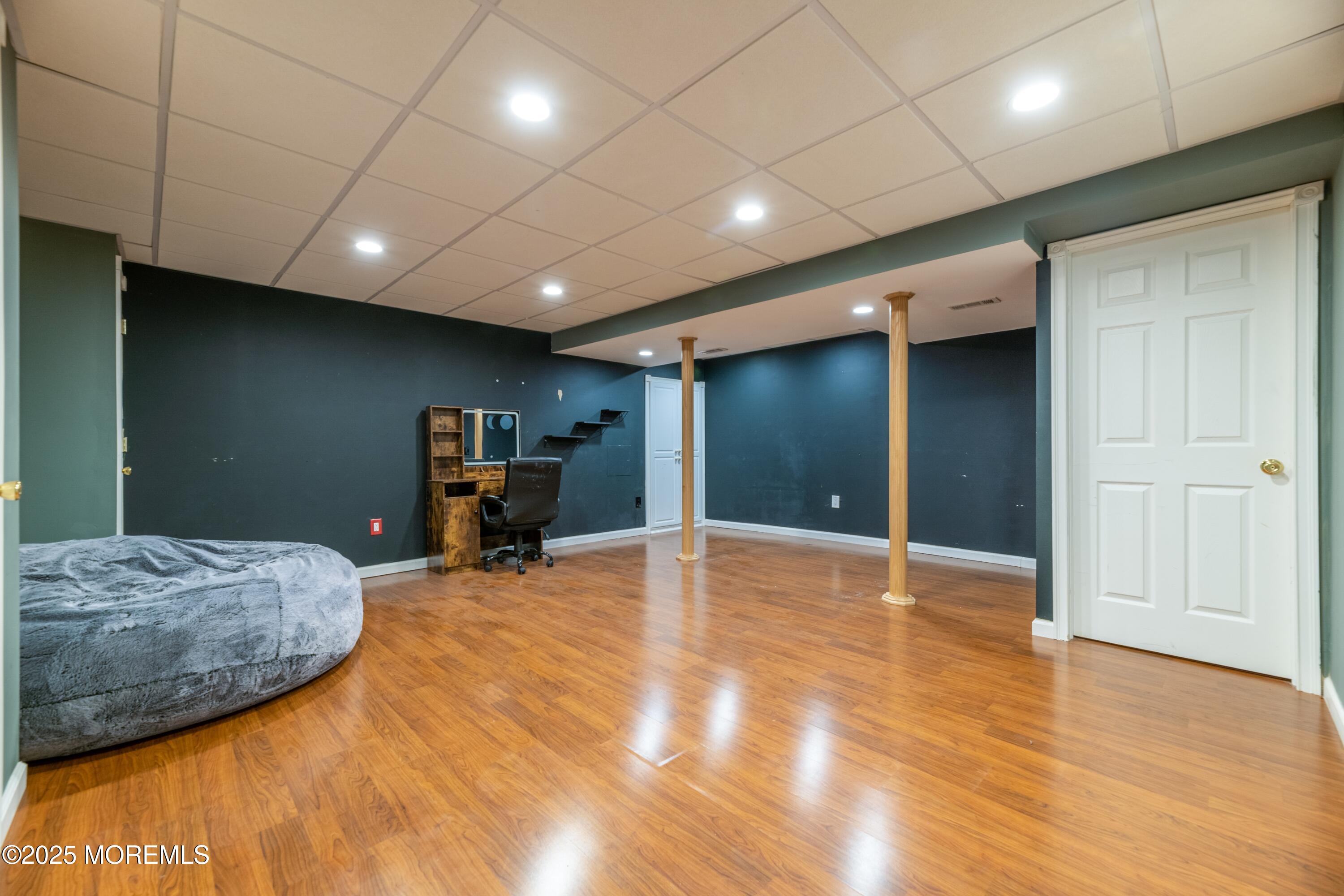 44 Manor Drive Marlboro, NJ 07746 - Photo 20 of 26 a view of a livingroom with furniture and a gym equipment