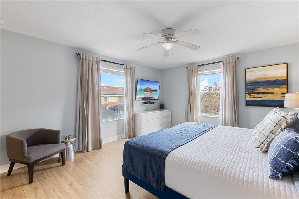 9006 Majesty Palm Road Kissimmee, FL 34747 - Photo 38 of 56 a bedroom with a bed and wooden floor