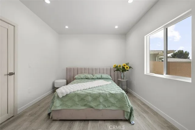 a bedroom with a bed and a potted plant