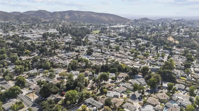 an aerial view of residential houses with city view