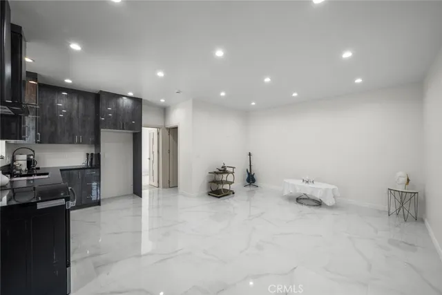 a kitchen with stainless steel appliances a refrigerator and a stove top oven