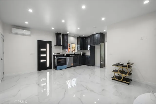 a kitchen with stainless steel appliances granite countertop a refrigerator and a stove