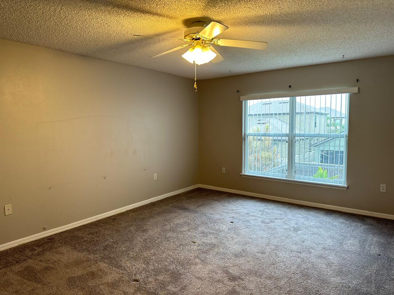 3844 La Flor Drive Rockledge, FL 32955 - Photo 20 of 32 an empty room with a window and a chandelier fan