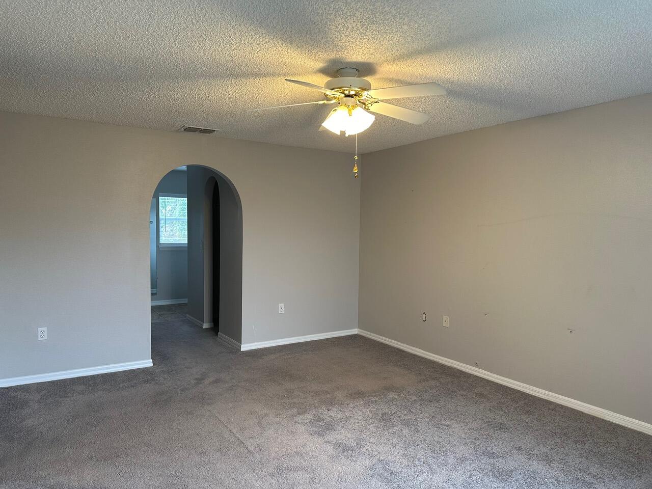3844 La Flor Drive Rockledge, FL 32955 - Photo 21 of 32 an empty room that has a chandelier fan and a bathroom