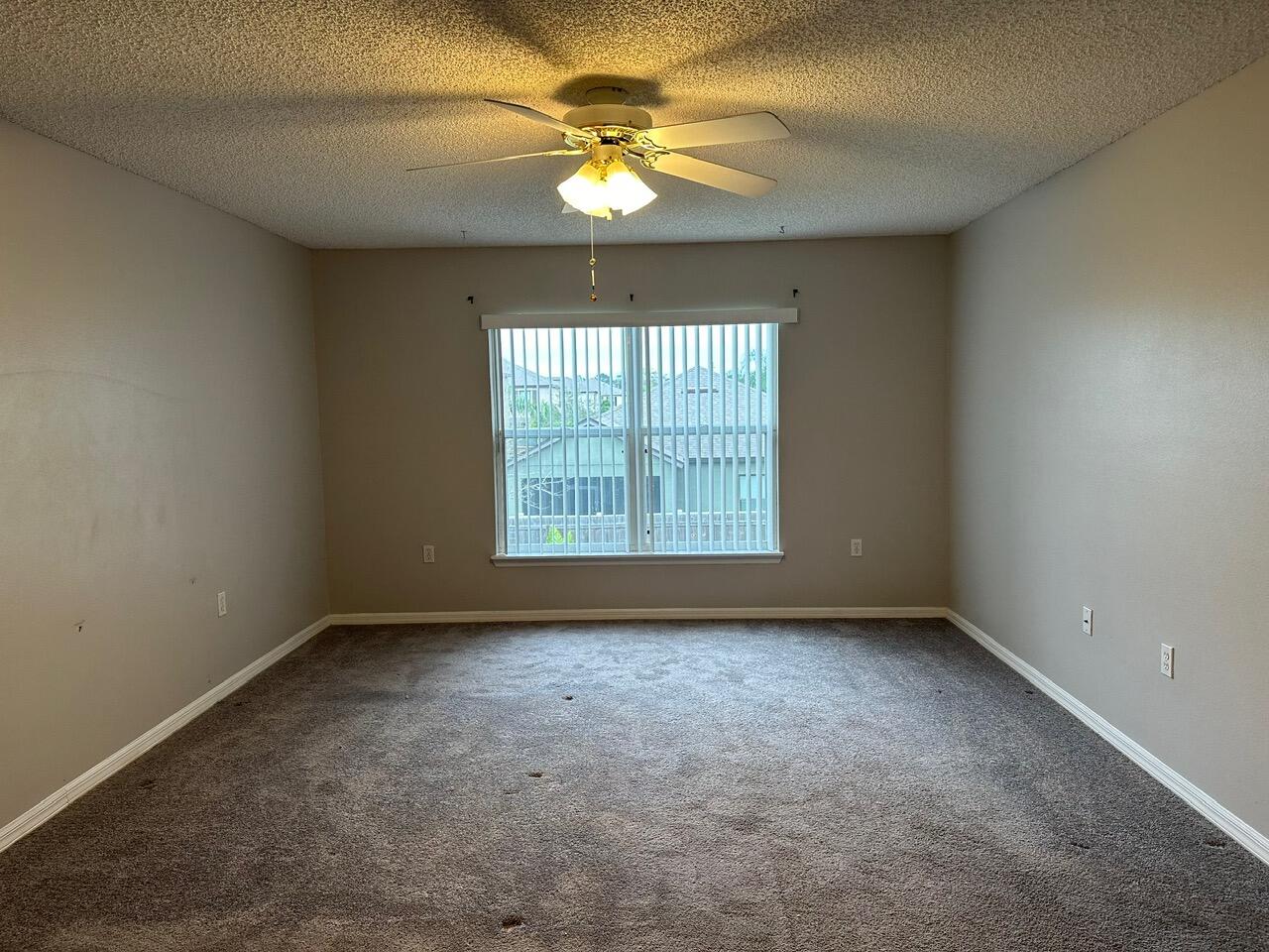 3844 La Flor Drive Rockledge, FL 32955 - Photo 27 of 32 an empty room with windows and chandelier fan