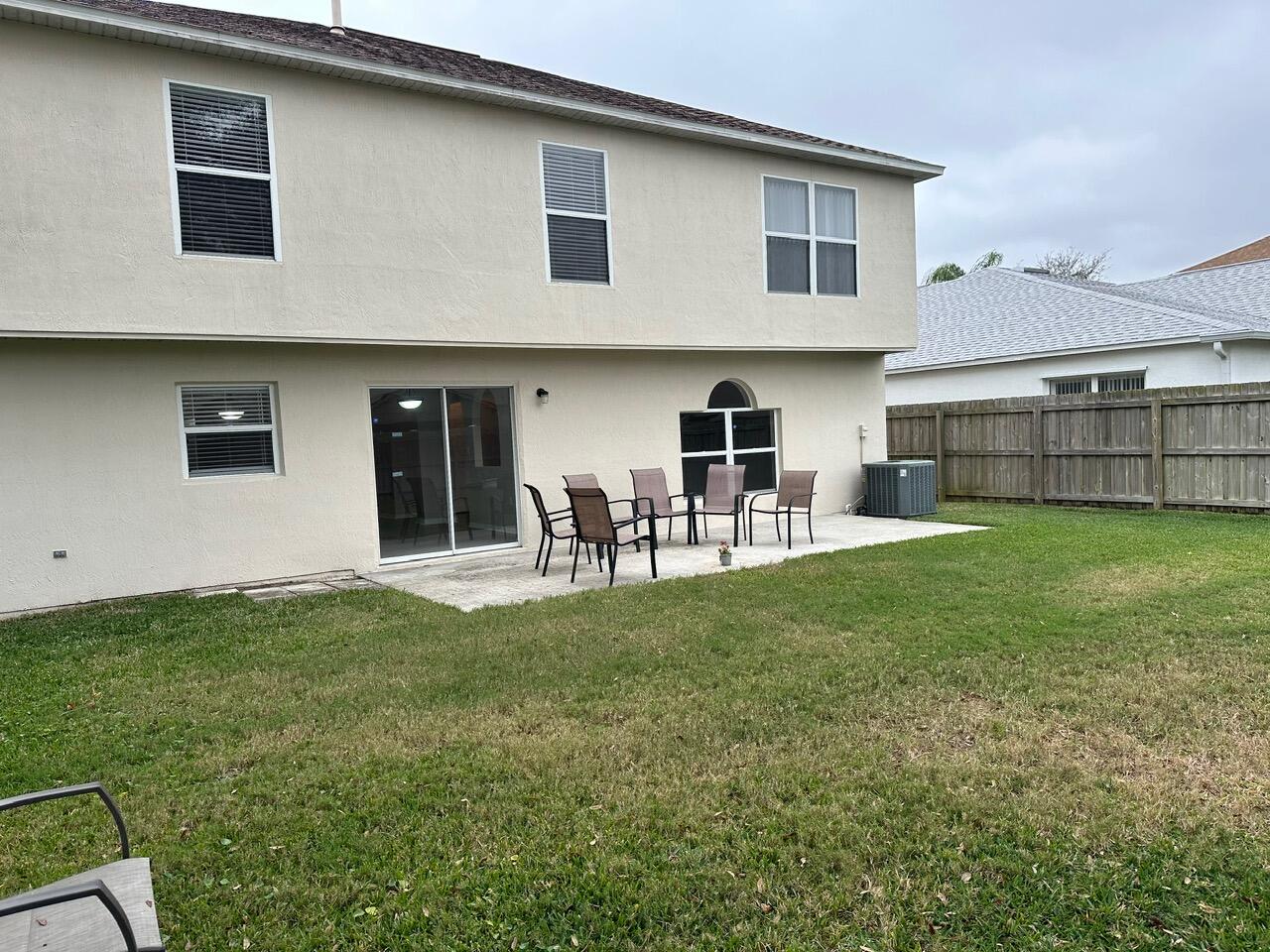 3844 La Flor Drive Rockledge, FL 32955 - Photo 31 of 32 a backyard of a house with table and chairs