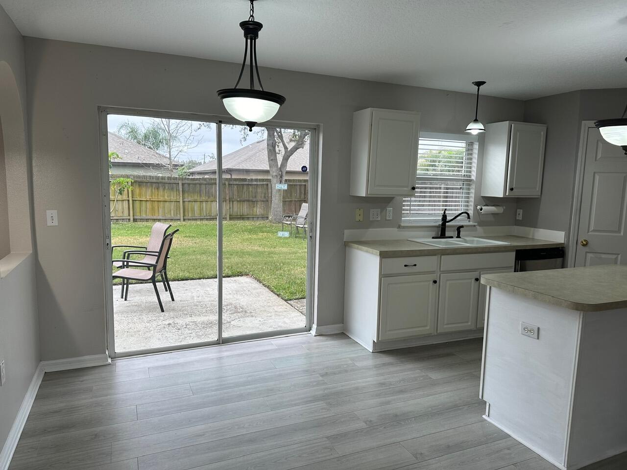 3844 La Flor Drive Rockledge, FL 32955 - Photo 4 of 32 a kitchen with kitchen island a large window and cabinets