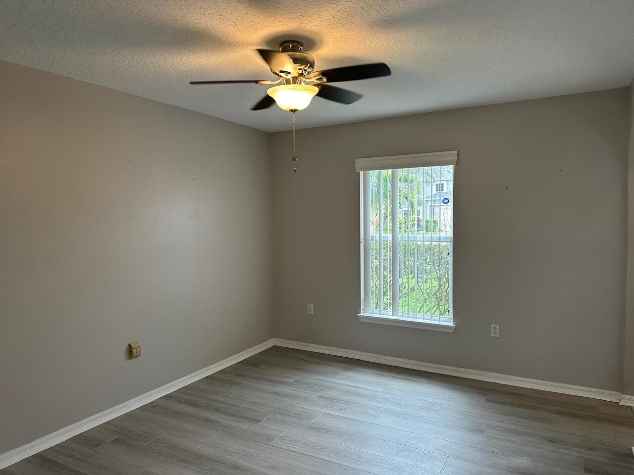 3844 La Flor Drive Rockledge, FL 32955 - Photo 5 of 32 an empty room with wooden floor and windows