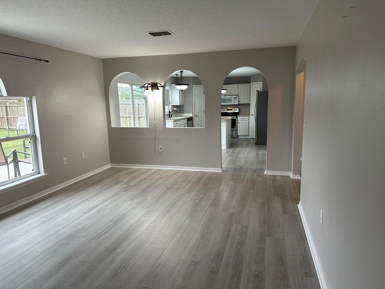 3844 La Flor Drive Rockledge, FL 32955 - Photo 10 of 32 wooden floor in an empty room with a window