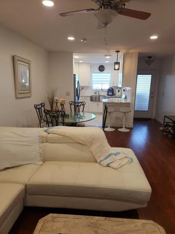 a living room with furniture and kitchen view