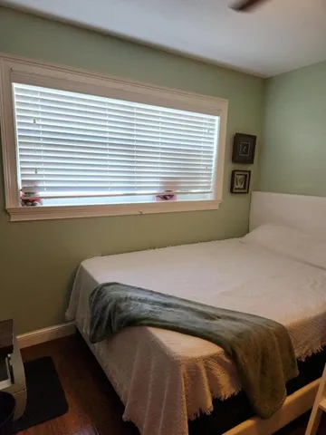 a bedroom with a bed and a window