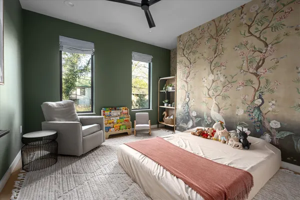 a living room with furniture large window and table