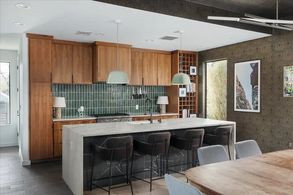 a room with a table chairs and a refrigerator