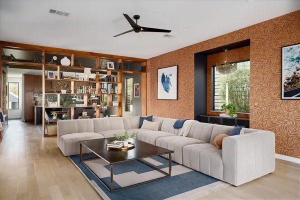 a living room with furniture and a floor to ceiling window