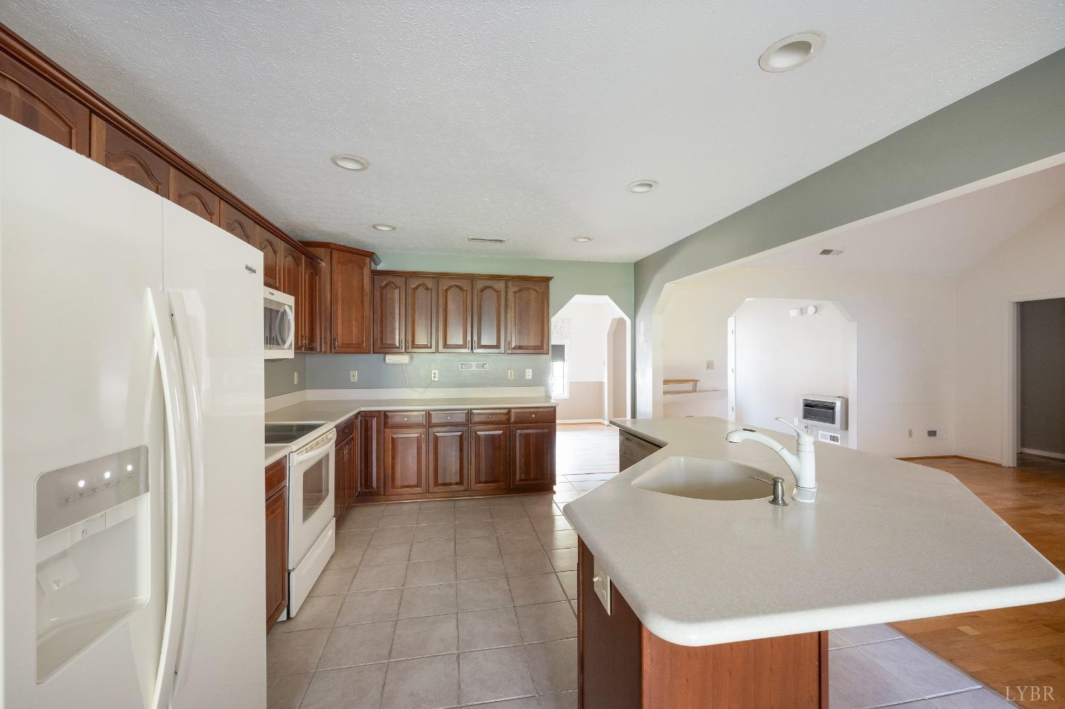 29 Dunivan Drive Rustburg, VA 24588 - Photo 19 of 61 a kitchen with stainless steel appliances granite countertop a sink a refrigerator and a stove