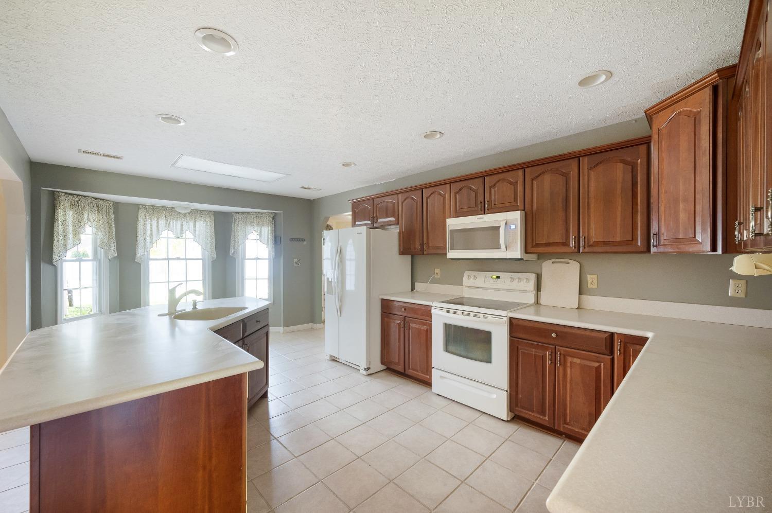 29 Dunivan Drive Rustburg, VA 24588 - Photo 20 of 61 a large kitchen with stainless steel appliances granite countertop a stove a sink dishwasher and a refrigerator