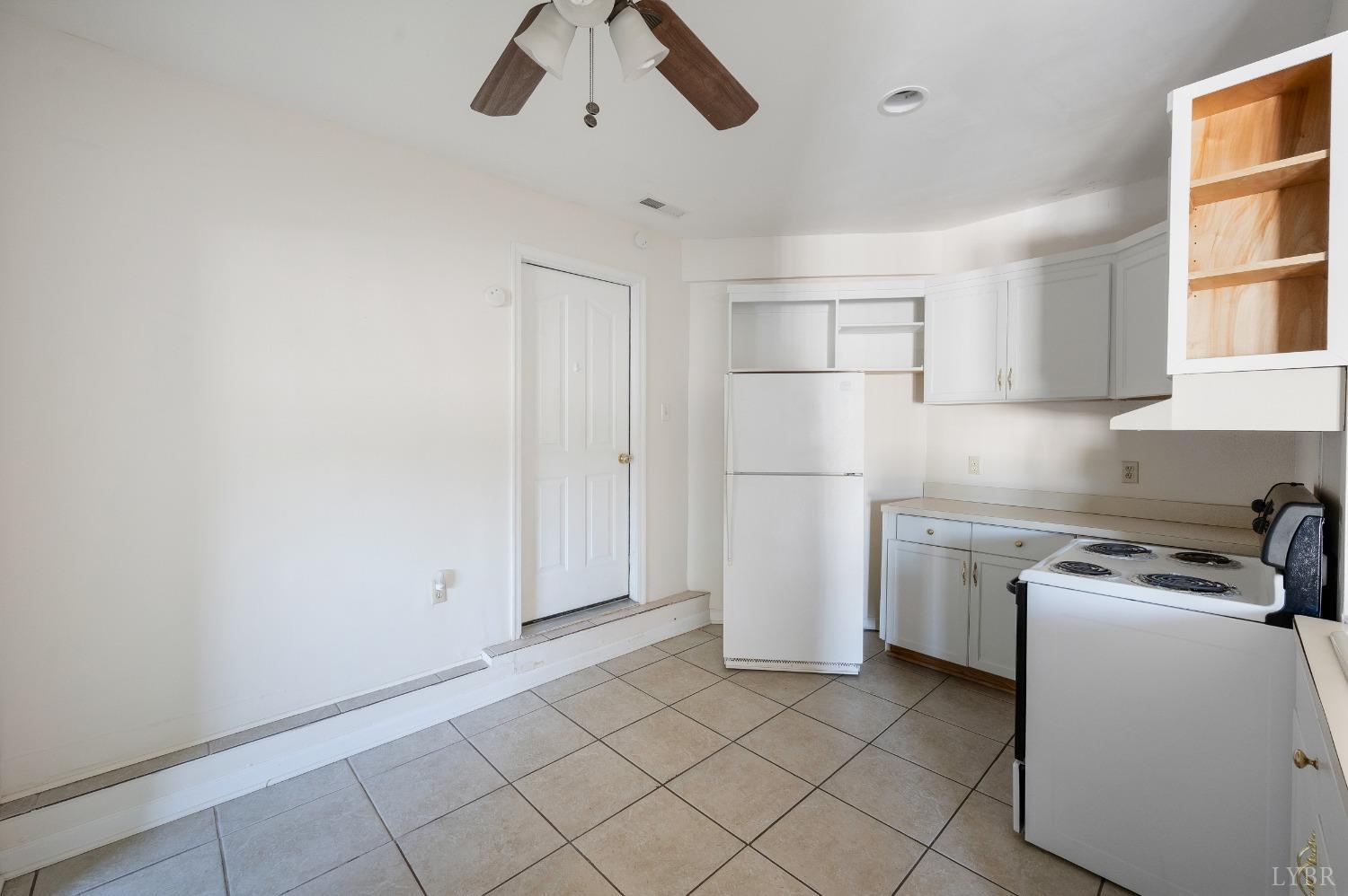 29 Dunivan Drive Rustburg, VA 24588 - Photo 28 of 61 a kitchen with white cabinets and white appliances