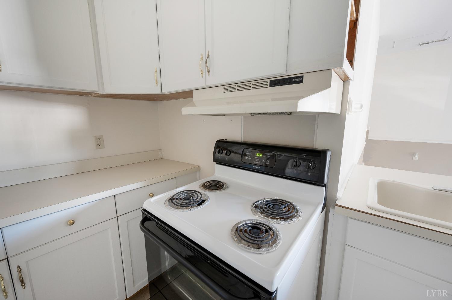 29 Dunivan Drive Rustburg, VA 24588 - Photo 31 of 61 a kitchen with a stove and white cabinets