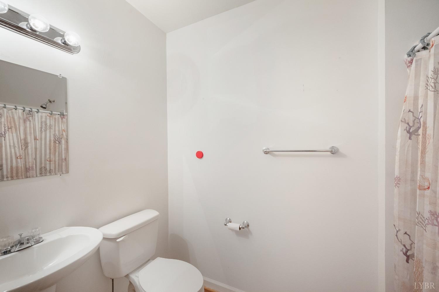 29 Dunivan Drive Rustburg, VA 24588 - Photo 39 of 61 a white toilet sitting next to a white sink and vanity